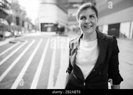 Mature businesswoman exploring the city of Bangkok, Thailand Stock Photo