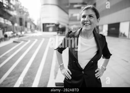 Mature businesswoman exploring the city of Bangkok, Thailand Stock Photo