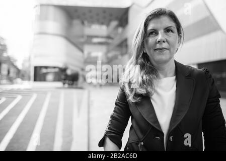 Mature businesswoman exploring the city of Bangkok, Thailand Stock Photo