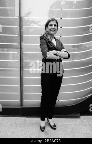 Mature businesswoman exploring the city of Bangkok, Thailand Stock Photo