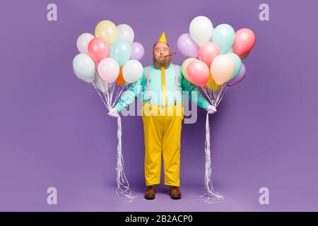 Full body photo shocked crazy excited fat man hold air baloons celebrate anniversary whistle noisemaker wear teal turquoise shirt bright trousers Stock Photo