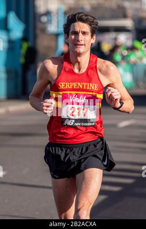 Andy Greenleaf racing in the Vitality Big Half half marathon crossing Tower Bridge, London, UK. Club runner with Serpentine running club Stock Photo