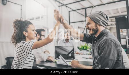 Business people happy showing team work and giving five in office. Teamwork concepts. Stock Photo
