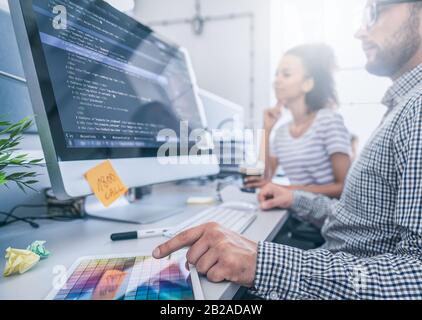 Developing programming and coding technologies. Website design. Programmer working in a software develop company office. Stock Photo