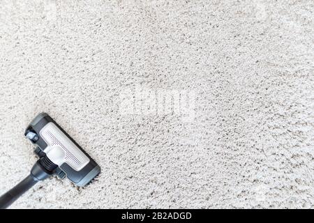 Cleaning carpet hoover. Carpet texture background. Stock Photo
