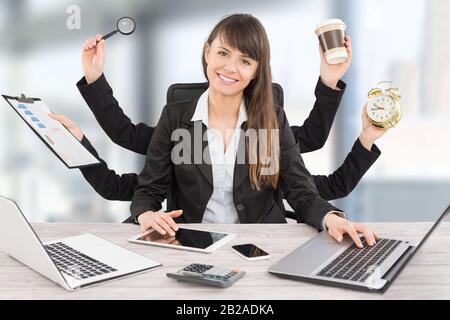 Multitask business woman with many hands. Performing several actions at the same time. Stock Photo