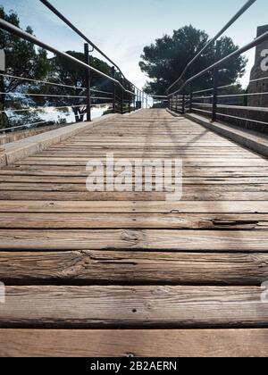 Natural planks wood pathway over moat protection of  castle. Vintage flooring timber. Stock Photo
