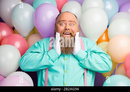 Astonished excited man big abdomen celebrate anniversary festive occasion get receive many gifts present impressed scream wow omg wear turquoise Stock Photo