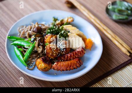 Japanese bento meal with meatballs, sausage and vegetables Stock Photo