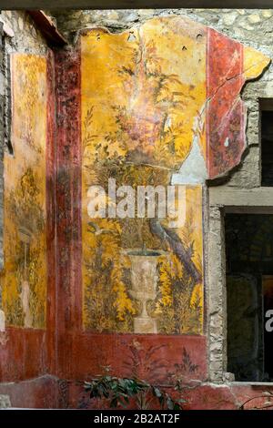 Oplontis Villa of Poppea - On the walls are represented, on a yellow and red background, gardens with beautiful fountains, Stock Photo