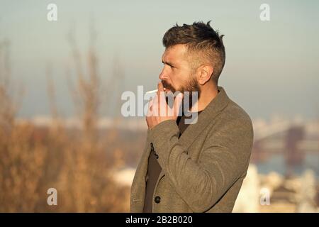 how to hide cigarette smell from mouth Cigarette tobacco harmful health influence. Smoking aesthetics. Smoking  devices concept. Bearded hipster smoking outdoors. Device hide conceal smell  of smoke. Handsome man smoke flying out of mouth Stock Photo