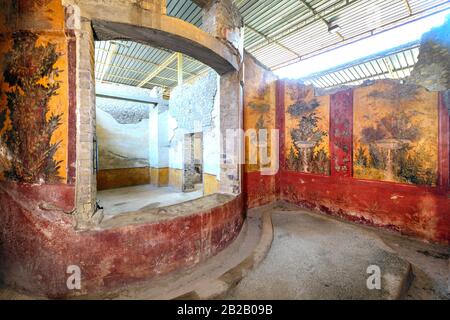 Oplontis Villa of Poppea - On the walls are represented, on a yellow and red background, gardens with beautiful fountains, Stock Photo