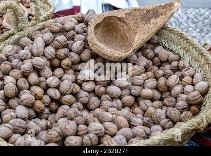 Autumn walnuts in basket. Background with autumn walnuts. Selective focus. Closeup. Stock Photo