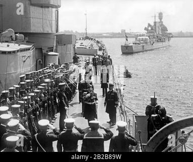 The German Admiral Albrecht visits the cruiser Ashigara of the Imperial Japanese Navy in Kiel together with its commander Rear Admiral Kobyashi. In the background, the German cruiser Karlsruhe. Stock Photo