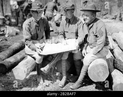 Army officers holding a plan for a Civilian Conservation Corps (A work relief program) camp in Virginia. Stock Photo