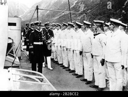 The photo shows Kaiser Wilhelm II (right) taking the salute of the enlisted cadets accompanied by the commander. Wilhelm is on a trip to Nordland and visits the cadet and ship-boy training ship 'Hertha' near Balholm. Stock Photo