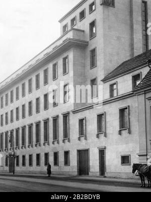 The photo shows the extension of the Reich Chancellery in Berlin. Two horses of a carriage stand in front of the Reich Chancellery. Stock Photo