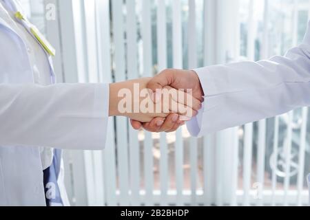 Close-up image of medical workers shaking hands when meeting in hospital Stock Photo