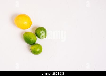 Lemon and three limes on a white background. Ripe citrus fruits Stock Photo