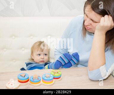 little boy and his mom play in developing the game Stock Photo