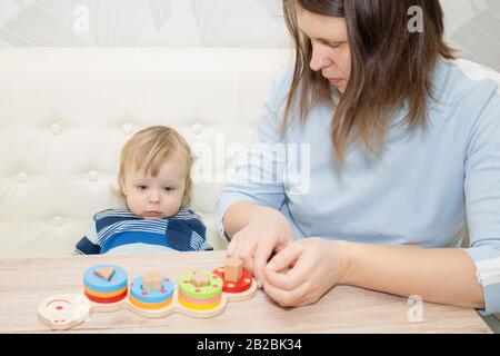 little boy and his mom play in developing the game Stock Photo