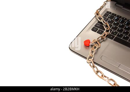 the laptop is in chains and a beautiful red closed lock. Limited access to data. Adult site. Stock Photo