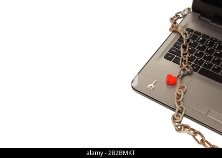 the laptop is in chains and a beautiful red closed lock. Limited access to data. Adult site. Stock Photo