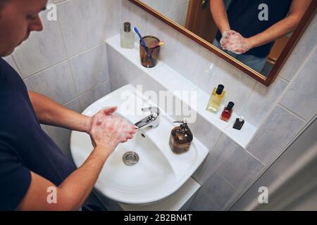 Washing hands at home in bathroom. Healthy lifestyle, hygiene and prevention viral and bacterial diseases. Stock Photo