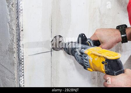 drill hole for electrical outlet outlet, special power tool drill Stock Photo