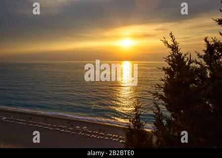 Beautiful colors of the sky at sunset over the sea, Milos beach on Lefkada island, Greece. Stock Photo