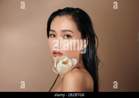 Beautiful girl with dried lotus buds. Beauty model woman face. Perfect skin. Stock Photo