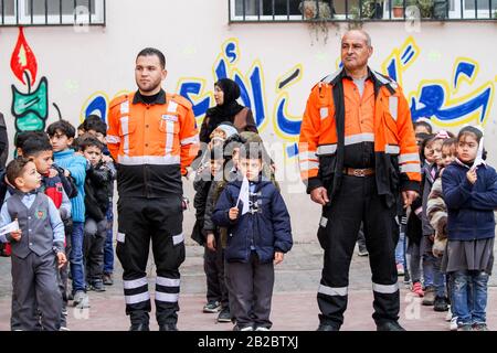 March 1, 2020: Gaza City, Palestine. 01 March 2020. The General Directorate of Palestinian Civil Defense in Gaza holds an event in the Al-Huda school on the east of Gaza City to provide awareness and familiarize the pupils about the vital tasks of the civil defence on the occasion of World Civil Defence day. World Civil Defence Day commemorates the entry into force of the International Civil Defence Organisation (ICDO) constitution as an intergovernmental organisation in 1972, with the aim to raise public awareness about the significance of the Civil Protection and the importance of preparedn Stock Photo