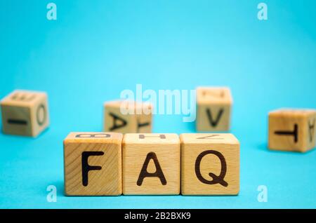 Wooden blocks with the word FAQ (frequently asked questions). Collection of frequently asked questions on any topic and answers to them. Instructions Stock Photo