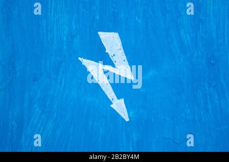 White sign danger electricity on steel blue painted wall in switchboard. Texture with paint stains and rusty Stock Photo