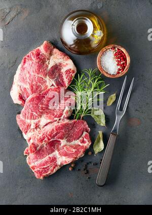 Pork meat with spices on a graphite board Stock Photo