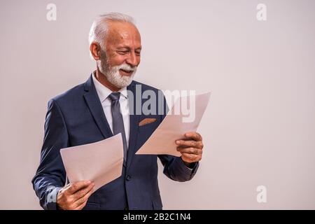 Portrait of happy and successful senior businessman. Stock Photo