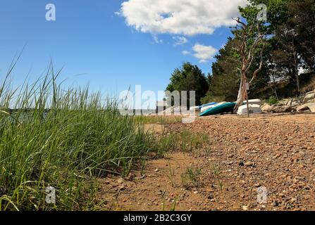Upturned boats stored on a beach Stock Photo