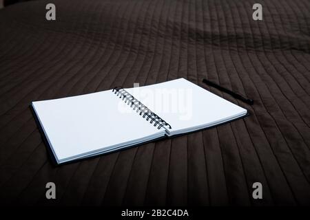 open notebook to point with a pen on a textile Stock Photo