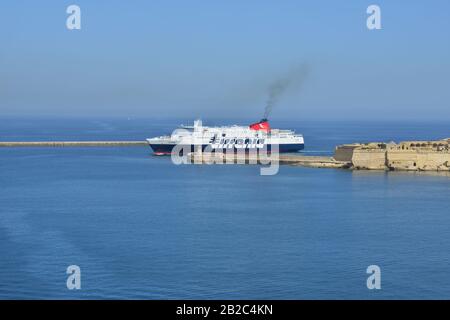 A small cruise liner ferry entering the Grand Harbour in Malta in Spring Stock Photo