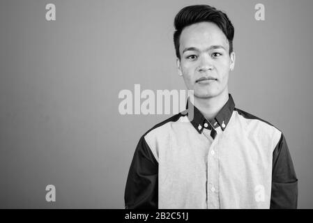 Portrait of young handsome Asian teenage boy looking smart Stock Photo