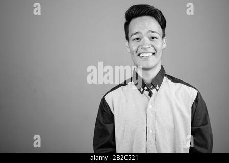 Portrait of young handsome Asian teenage boy looking smart Stock Photo