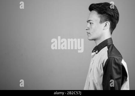 Portrait of young handsome Asian teenage boy looking smart Stock Photo