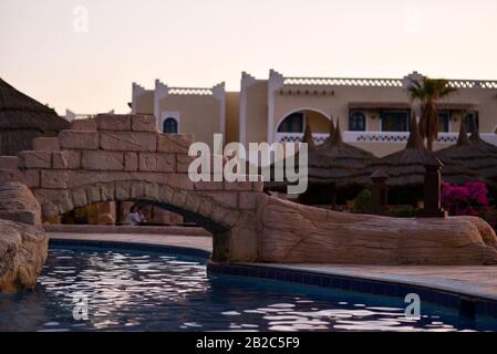 Bridge over the pool at the hotel in the evening. Stock Photo