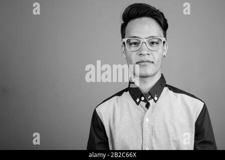 Portrait of young handsome Asian teenage boy looking smart Stock Photo