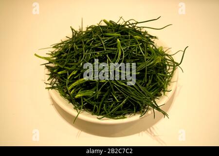 A closeup of a plate of agretti, or salsola soda, raw ready to be cooked Stock Photo