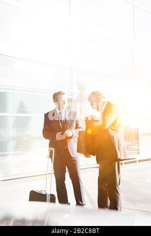 Businessmen standing while talking in the airport Stock Photo