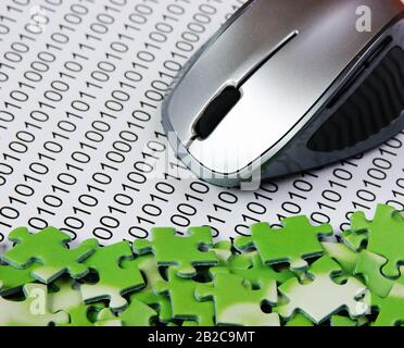 computer mouse and  puzzles on a binary code Stock Photo