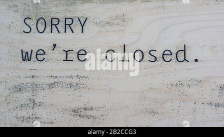 Sorry we are closed sign on a wooded board Stock Photo