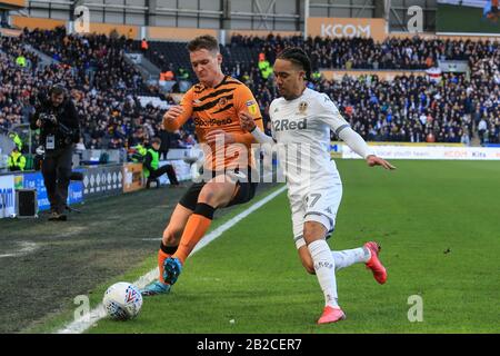 29th February 2020, KCOM Stadium, Hull, England; Sky Bet Championship, Hull City v Leeds United : Sean McLoughlin (17) of Hull City and Helder Costa (17) of Leeds United challenge for the ball Stock Photo