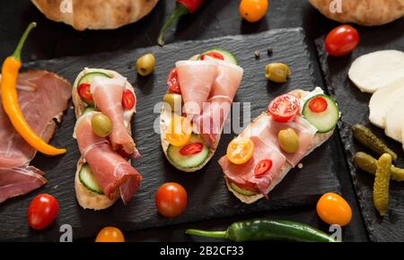 Prosciutto canapes on granite board - top view Stock Photo